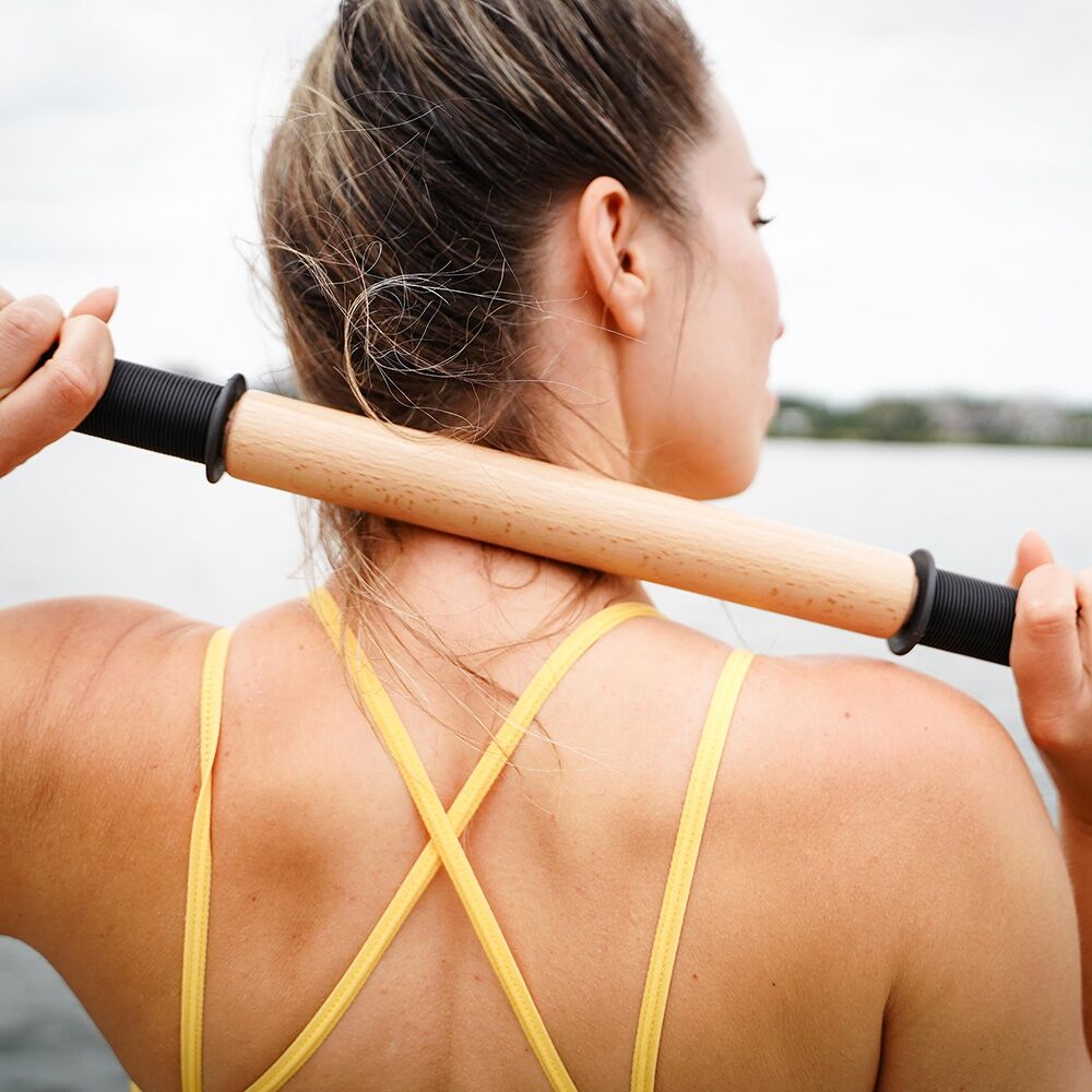 Woman Rolling her neck with ReGreen The Original 18" Wood Roller Massage Stick