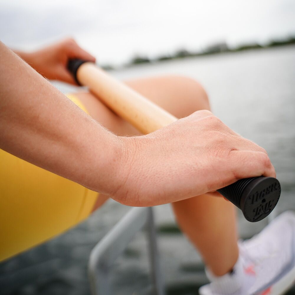 Woman Rolling her leg with ReGreen The Original 18" Wood Roller Massage Stick