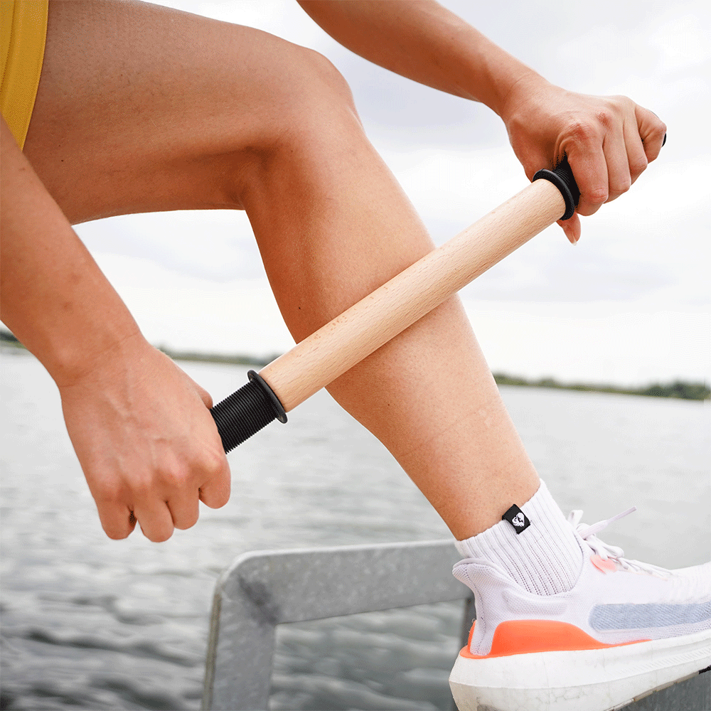 Woman Rolling her leg with ReGreen The Original 18" Wood Roller Massage Stick Animated